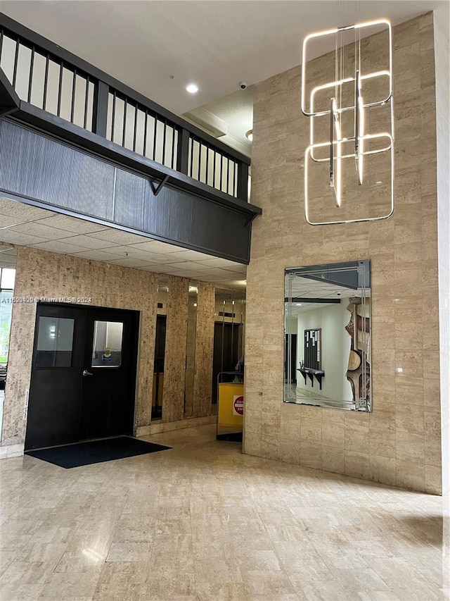 2750 NE 183rd St Unit 1210, Aventura, FL 33160 - lobby featuring a surveillance system and a towering ceiling