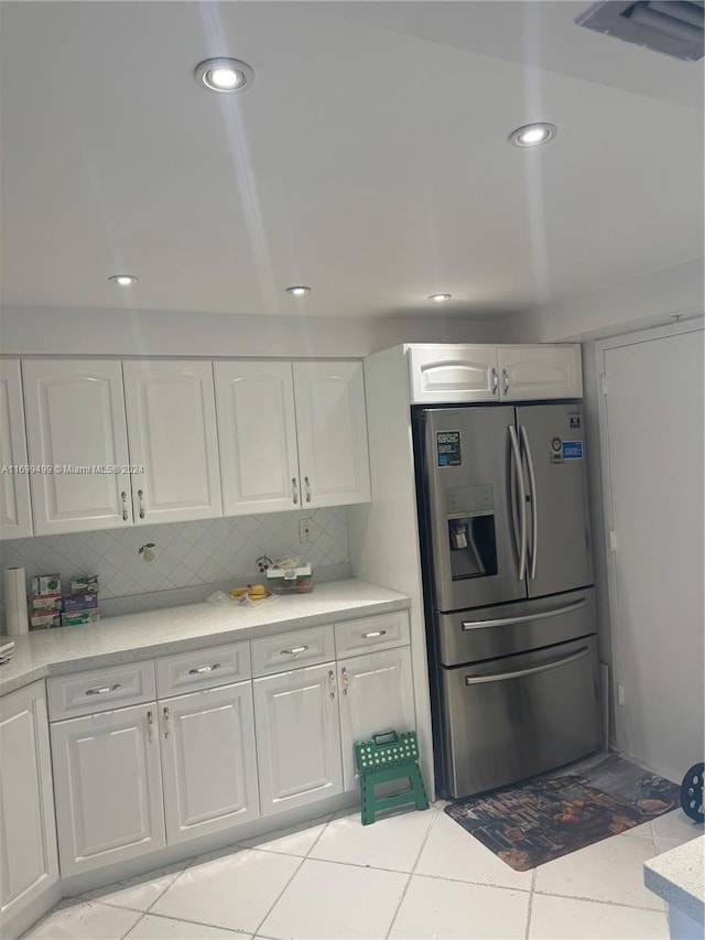 2750 NE 183rd St Unit 1210, Aventura, FL 33160 - kitchen with stainless steel fridge, white cabinetry, light countertops, decorative backsplash, and recessed lighting