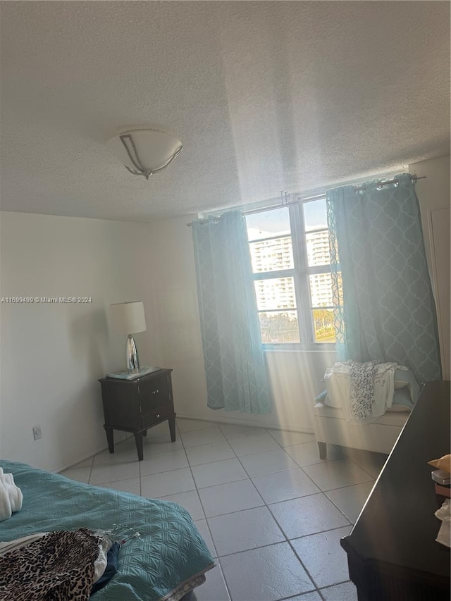 tiled bedroom with a textured ceiling