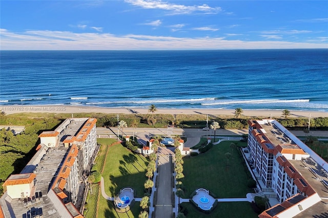 birds eye view of property with a water view and a view of the beach