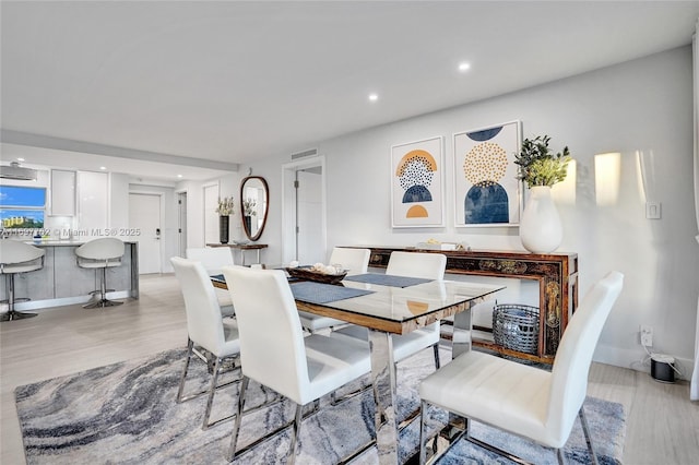 dining space with light wood-type flooring