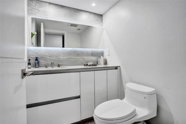 bathroom featuring vanity and toilet