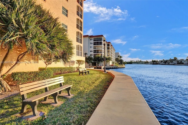 view of community with a yard and a water view