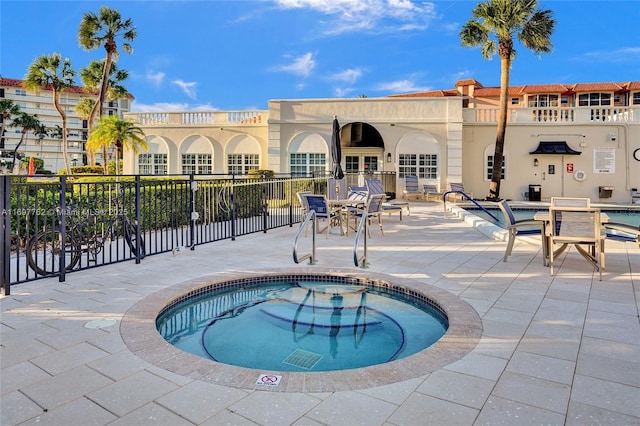 view of pool with a community hot tub and a patio area