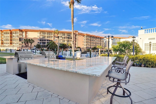 view of patio / terrace with exterior bar and area for grilling