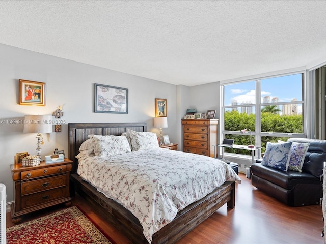 bedroom featuring a textured ceiling and hardwood / wood-style floors