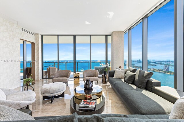 living room featuring a water view and a wall of windows