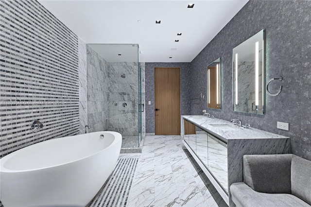 bathroom with double vanity, a marble finish shower, a soaking tub, marble finish floor, and a sink