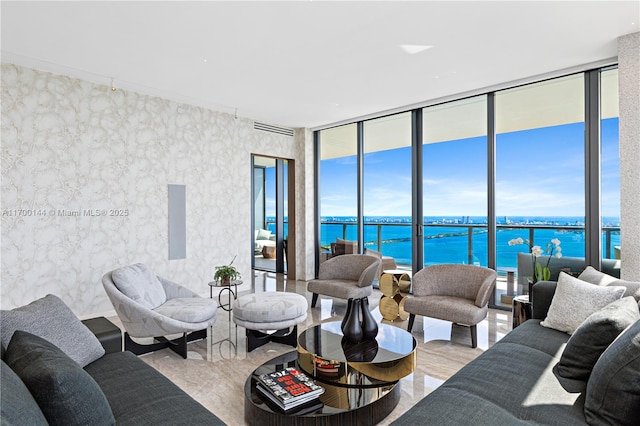 living room with a water view and a wall of windows