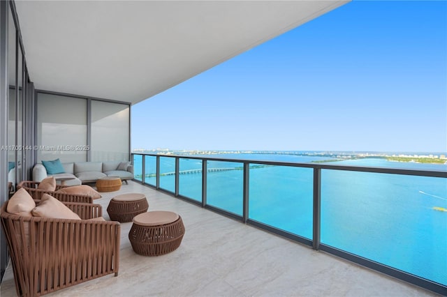 balcony with a water view and outdoor lounge area