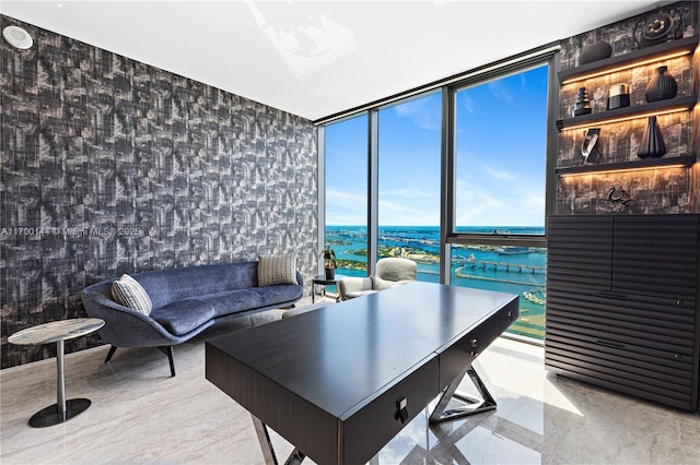 home office with a wall of windows and a water view