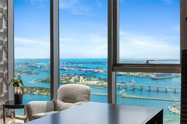 interior space with floor to ceiling windows and a water view