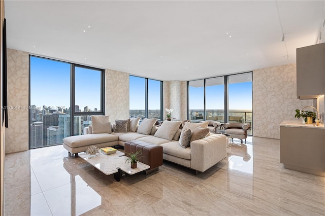 living room with a healthy amount of sunlight, a wall of windows, and a city view