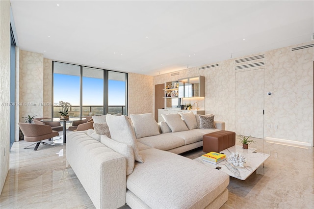 living room featuring marble finish floor and expansive windows