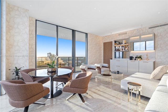 living room featuring floor to ceiling windows and bar area