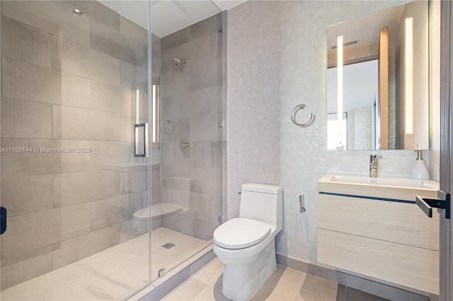 bathroom featuring vanity, a shower stall, and toilet