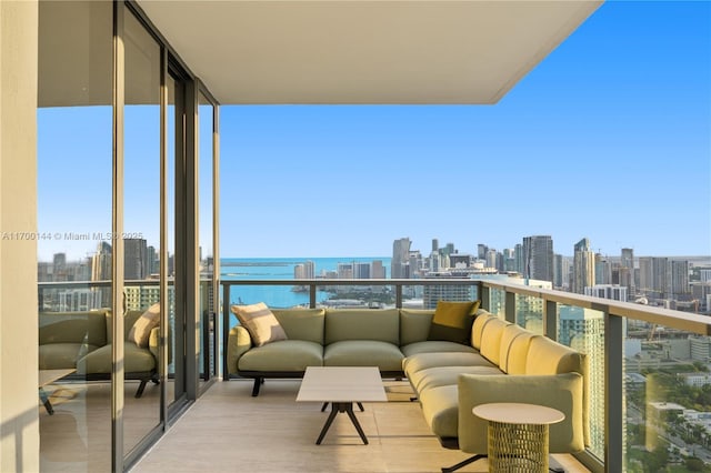 balcony with a water view and a view of city