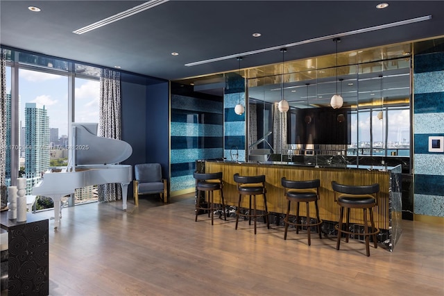 bar featuring hardwood / wood-style flooring and floor to ceiling windows