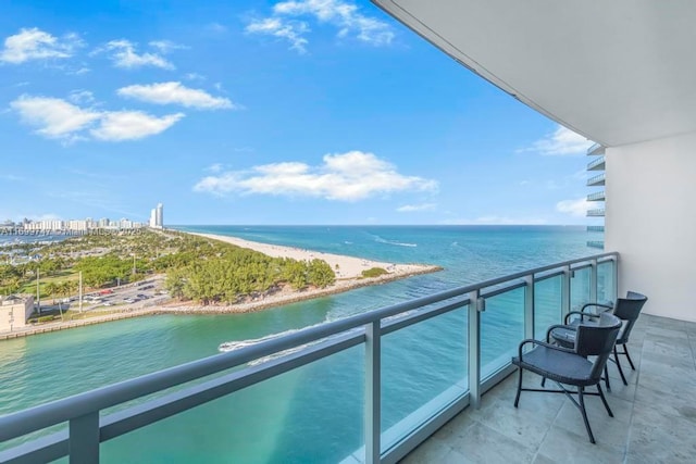 balcony with a beach view and a water view