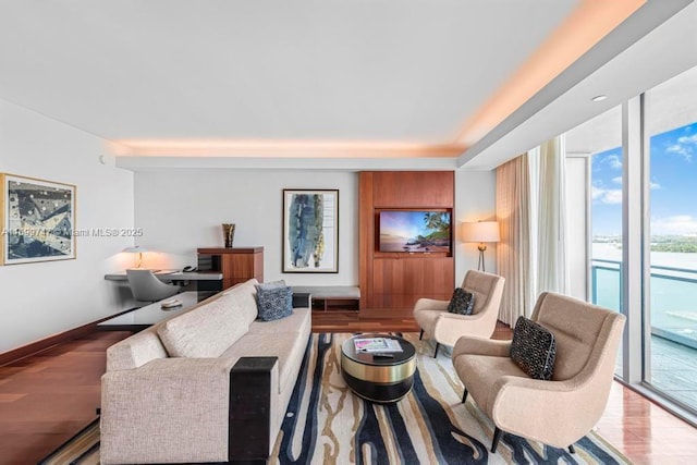 living room with light hardwood / wood-style flooring and a wall of windows