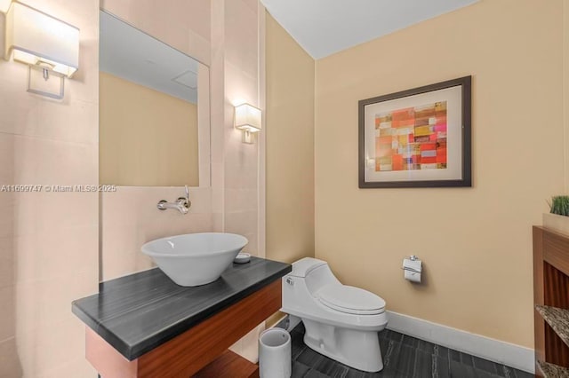 bathroom with tile patterned floors, vanity, and toilet