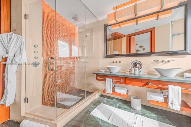 bathroom with tile patterned flooring, vanity, backsplash, and an enclosed shower