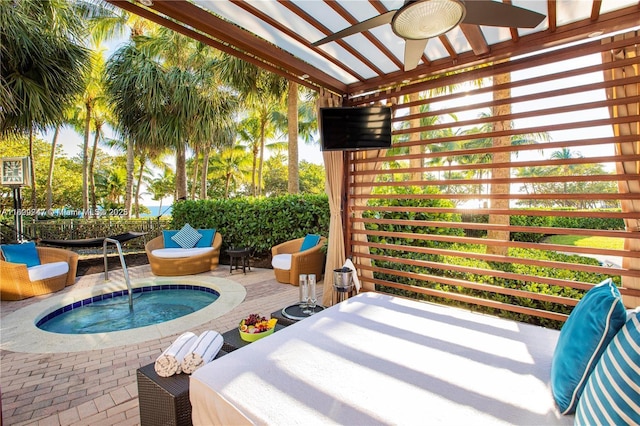 view of patio featuring ceiling fan and an in ground hot tub