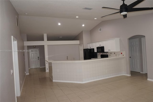 kitchen featuring high vaulted ceiling, black appliances, white cabinets, light tile patterned floors, and kitchen peninsula