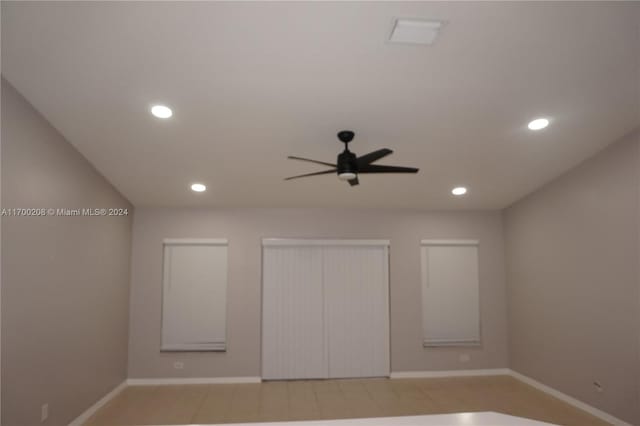 unfurnished bedroom with ceiling fan and light tile patterned flooring