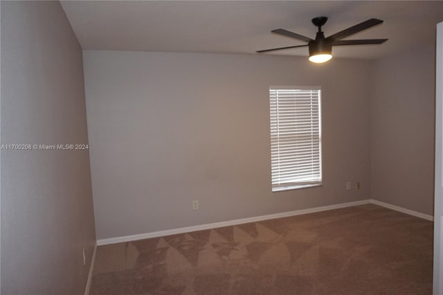 carpeted empty room featuring ceiling fan