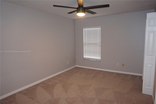 unfurnished room featuring carpet and ceiling fan