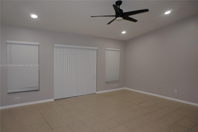 unfurnished bedroom with ceiling fan, light tile patterned flooring, and multiple closets