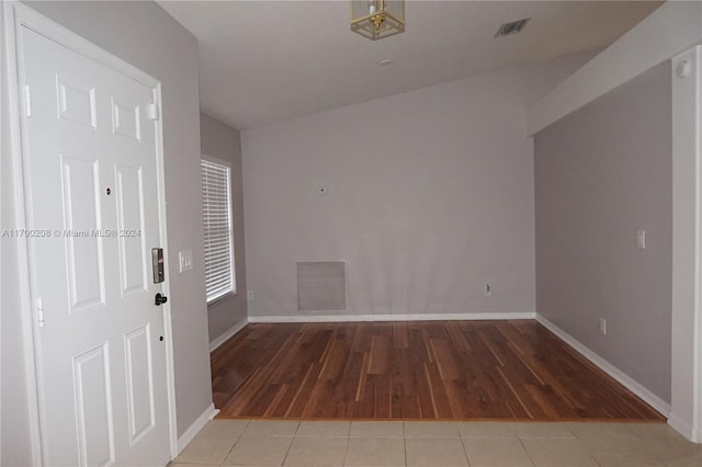 entrance foyer featuring vaulted ceiling and light hardwood / wood-style flooring