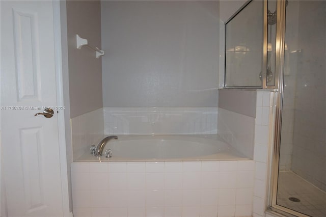 bathroom featuring separate shower and tub