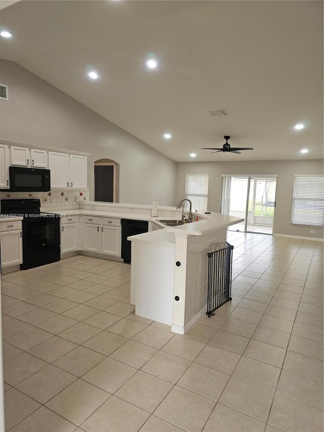 kitchen with black appliances, light tile patterned floors, sink, and tasteful backsplash