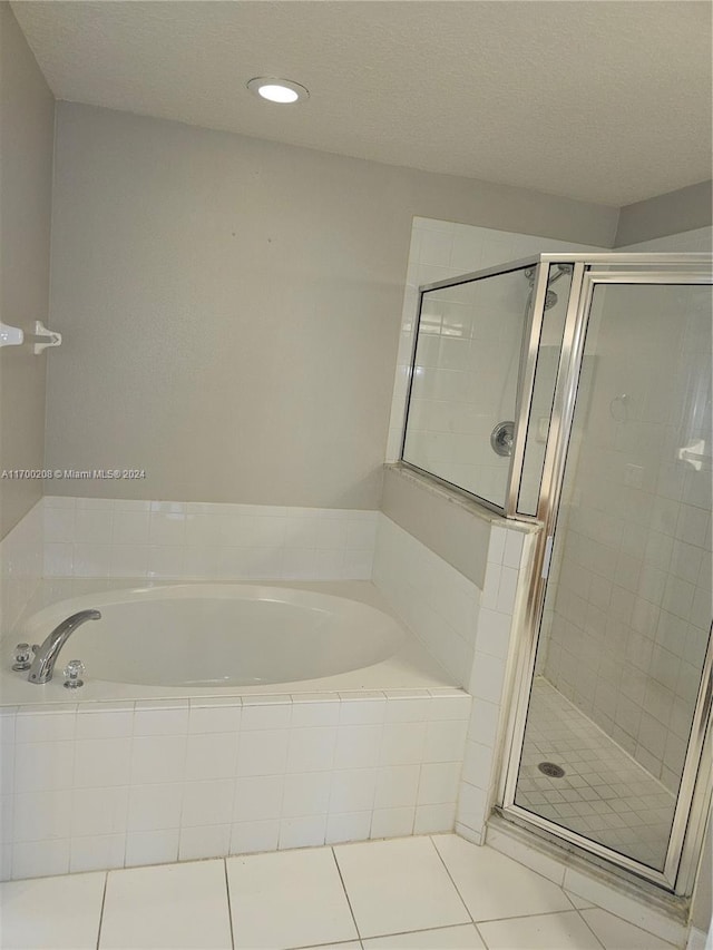 bathroom featuring tile patterned flooring and separate shower and tub