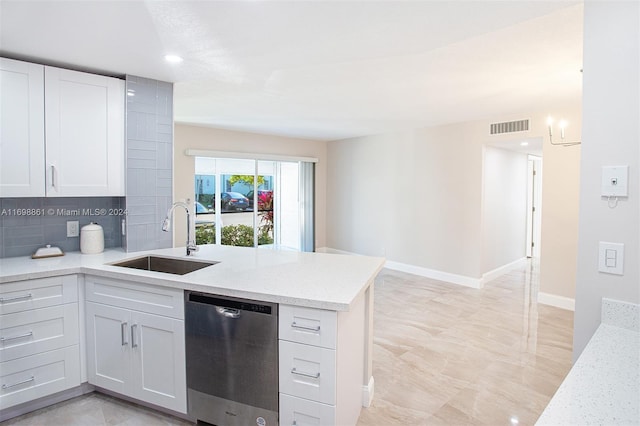 kitchen featuring dishwasher, sink, light stone counters, backsplash, and white cabinets