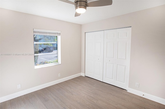 unfurnished bedroom with ceiling fan, light hardwood / wood-style flooring, and a closet