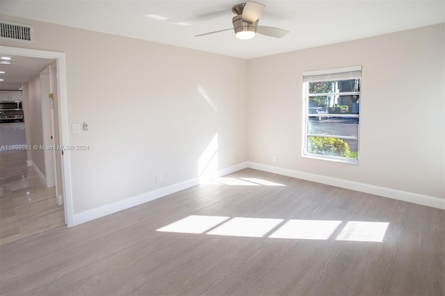 unfurnished room featuring ceiling fan and light hardwood / wood-style floors