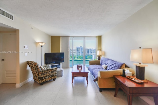 living room featuring a wall of windows and a textured ceiling