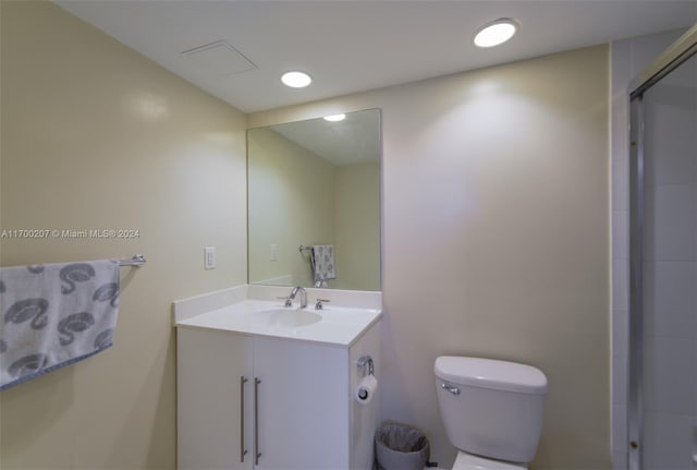 bathroom featuring vanity, toilet, and an enclosed shower