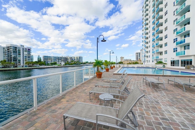 view of pool featuring a water view