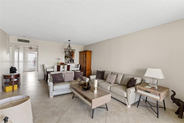 living room featuring light tile patterned floors and a textured ceiling