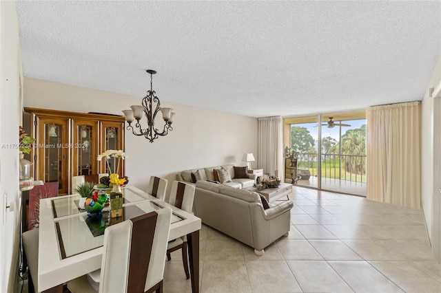 tiled dining area with a textured ceiling, an inviting chandelier, and floor to ceiling windows