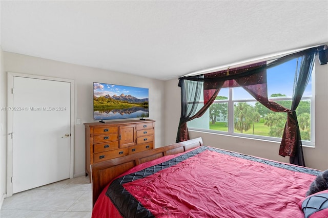 tiled bedroom featuring a textured ceiling