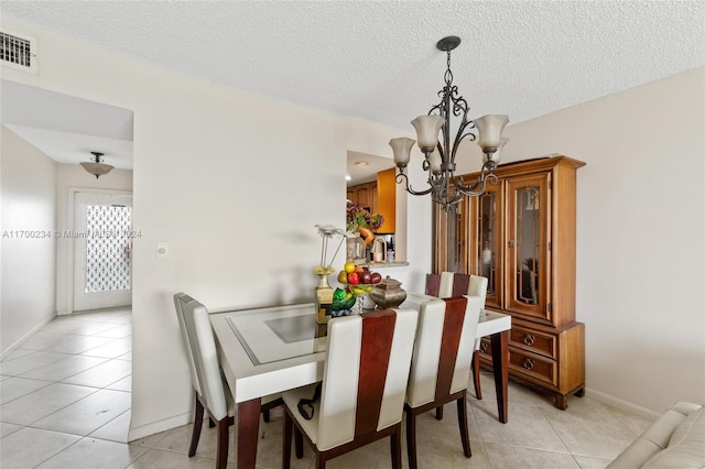 7690 NW 18th St Unit 408, Margate, FL 33063 - dining area featuring a chandelier, light tile patterned flooring, and a textured ceiling