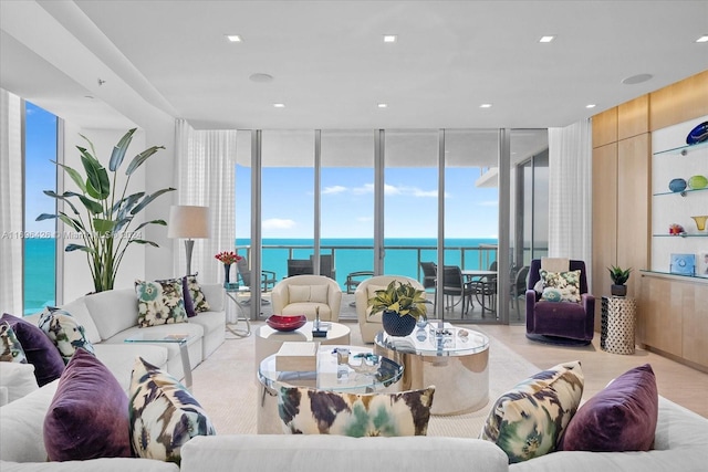 living room with a water view and floor to ceiling windows