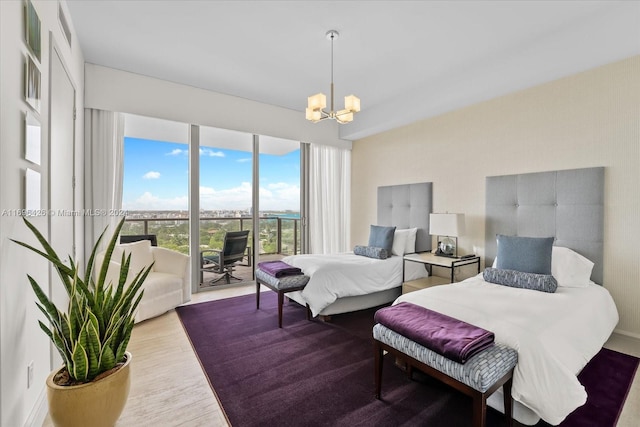 bedroom with access to exterior, light hardwood / wood-style flooring, and a notable chandelier