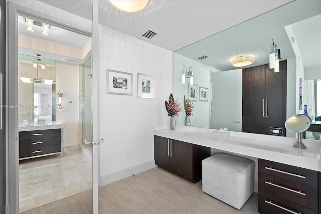 bathroom featuring vanity, wood-type flooring, and walk in shower