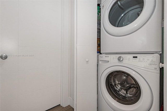 laundry area featuring stacked washer / drying machine